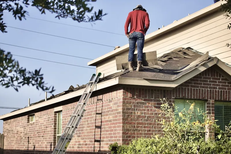 Professional roofer working on a residential roof in Leafy Dell